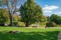 Parisians sunbathing on the shore of the lake of Parc Montsouris - Paris, France