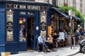 Parisians and tourists eating and drinking on the terrace of the bistro Le Bon Georges. Paris, France