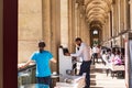 Parisians and tourists enjoy summer day drinks in cafe on a terrace of Louvre Royalty Free Stock Photo