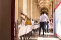 Parisians and tourists enjoy summer day drinks in cafe on a terrace of Louvre Royalty Free Stock Photo