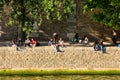 Parisians and tourists have picnic and relax on the Seine River