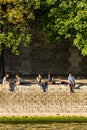 Parisians and tourists have picnic and relax on the Seine River