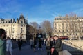 Parisians and tourists strolling on the Saint Michel bridge in Paris Royalty Free Stock Photo