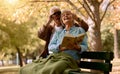 Park, bench and binoculars with a senior couple birdwatching together outdoor in nature during summer. Spring, love and Royalty Free Stock Photo