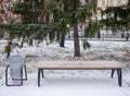 A park bench covered with the first snow Royalty Free Stock Photo