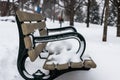 Park Bench covered in snow Royalty Free Stock Photo