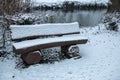 Park bench covered with snow in winter Royalty Free Stock Photo