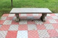 park bench front red stone footpath and green grass backside