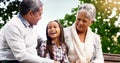 Park, bench and happy grandparents with child, smile and bonding on outdoor adventure together. Old man, senior woman Royalty Free Stock Photo