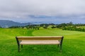 Park bench outdoor landscape. Wooden bench in golf course landscape. Mountain park bench panorama. Park bench relax Royalty Free Stock Photo