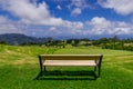 Park bench outdoor landscape. Wooden bench in golf course landscape. Mountain park bench panorama. Park bench relax Royalty Free Stock Photo