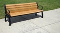 Park bench by a sidewalk Royalty Free Stock Photo