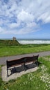 Park bench view of the castle ruins in Ballybunion county Kerry Ireland on the wild Atlantic Way