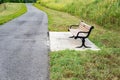 Park Bench by a Walking Path Royalty Free Stock Photo