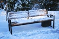 Park bench in winter is covered with snow after a snowfall Royalty Free Stock Photo