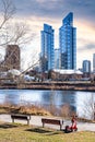 Park benches and E-scooter overlook the Bow River with new apartment buildings near downtown Calgary Alberta Canada Royalty Free Stock Photo