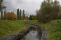 park city garden water reflection trees red yellow autumn clouds rain landscape weather Royalty Free Stock Photo