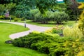 Park with curved path paved with stone tiles in park among plants. Royalty Free Stock Photo