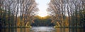 Park in the fall in the sun. Reflection in water and mirror symmetry