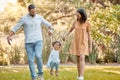 Park, family and holding hands with flying child for fun, bond and wellness walk together. Happy, mother and dad with Royalty Free Stock Photo