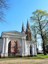 Park gate and red church, Lithuania Royalty Free Stock Photo