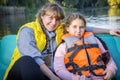 In the park, a girl with her mother is sailing on a boat Royalty Free Stock Photo