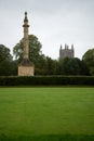 Park and grass with Hereford cathedral and memorial column in background