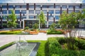 Park with green bushes, fountains and benches in Royalty Free Stock Photo