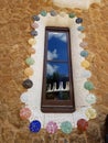 Park Guell House Window With An Unique Colourful Frame. Sky And Clouds Reflected In The Window