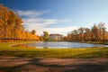 Park with a lordly castle behind a pond in autumn Royalty Free Stock Photo