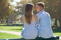 Park, love and relax couple smile for outdoor sunshine, wellness and romantic date in nature. Happy, commitment and back