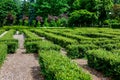 Park maze of green bushes in the backyard with pebbled walking trail. Royalty Free Stock Photo