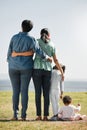 Park, nature and back view of family on grass outdoors with relatives spending quality time together. Love, support and