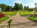 In the park near the river, a wide road is divided into three alleys going in different directions. Conceptual summer Royalty Free Stock Photo