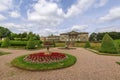 Large circular flower bed with Edwardian tazza stone planter in a landscaped English park. Royalty Free Stock Photo