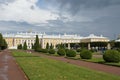 Park in Peterhof, with a green lawn and a palace in front, a landmark, showplace in St. Petersburg