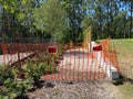 A park with a playground and nature with caution tape and no trespassing signs all over the equipment is closed because of the