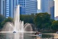 Park with a pond in Asia. Beautiful Bangkok. The building in the vegetation. A green city.