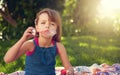Park, portrait and child blowing bubbles on grass in nature, relax and kid having fun on blanket outdoor. Toy, garden Royalty Free Stock Photo
