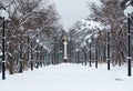 Park road with symmetric light poles and the statue of the angel of peace