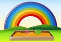 Park scene with sandpit and rainbow