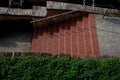 Park staircase on the terrace of an Italian garden. the stairs are made of red bricks glued to cement. forged metal railing on the Royalty Free Stock Photo