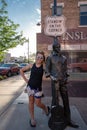 July 1 2018 - WINSLOW AZ: Adult female tourist stands on the corner with Jackson Browne of the Eagles. Royalty Free Stock Photo