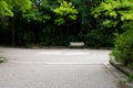 A park surrounded by green trees with stone-paved road in Canada. Royalty Free Stock Photo