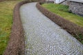 Park there are hedges of evergreen shrubs. benches stand along the sidewalk in the square. granite tiles mosaic. shrubs pruning a