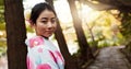 Park, traditional and portrait of Japanese woman for wellness, fresh air and relax outdoors. Travel, culture and person