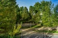 Park with trees and benches along riverbank Royalty Free Stock Photo