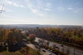 Park Trees with yellow autumn leaves blue sky with clouds city houses Royalty Free Stock Photo