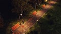 Park walkway lit by street lamps at autumnal night Royalty Free Stock Photo