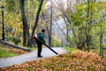 A park worker removes fallen leaves in one of the parks in downtown of Kyiv, Ukraine. October 2019